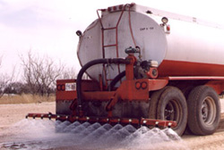 Liquid Magnesium Chloride being applied to an unpaved road